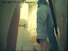 Blonde female is pissing on toilet opposite working cam