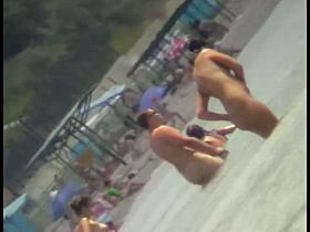 Voyeur view of fun in the water on a nudist beach