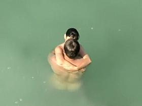 Spying two teenagers fuck in the water