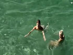 Nudists swimming in the beach