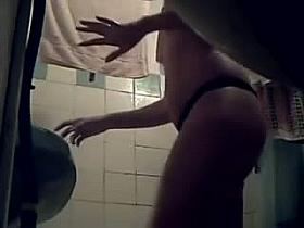 A sexy woman takes a shower for the hidden camera
