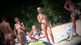 Blonde sexy completely nude woman standing on a beach porno