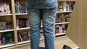 Chick's butt pops out when she bends over to pick up a book