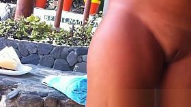 Spying on a cute cutie at the nudist beach voyeur cam