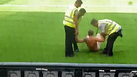 Nude maniac runs around the football field