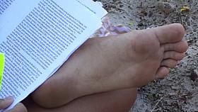 Candid soles at beach - teen studying