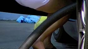 Blonde MILF shows cleavage and ass at the carwash