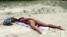 Bikini girl masturbates solo at the beach