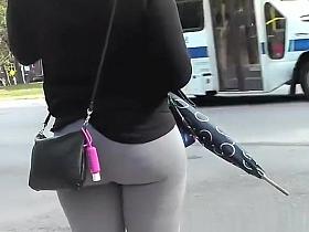 Girl wearing gray leggings has nice round ass