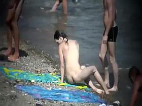 Skinny nude girl creeped on at a beach