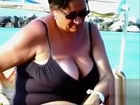 Large saggy breasts in bikini tops by the pool