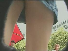 Cute brunette babe in the park offers sexy upskirt view