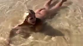Naked models have fun on a beach vacation