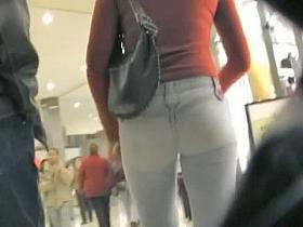 Cute brunette walking her ass in tight jeans on candid cam