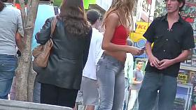 candid skinny tanned ad girl standing on the street in tight clothes