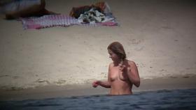 Perky breasted sweetie with a full bush followed on a nudist beach