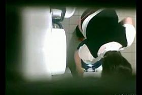 Female is pissing on toilet and getting shot from above