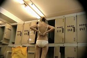 Slender girl showing nude back on the voyeur camera