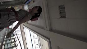 Teen on escalator notices the upskirt hunter