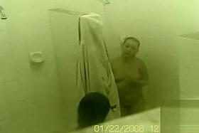 Two good looking babes get caught on camera showering