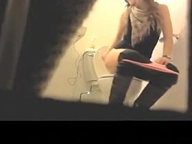 Blonde girl peeing in bathroom