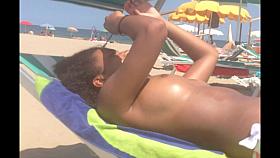 Topless ebony teen on the beach