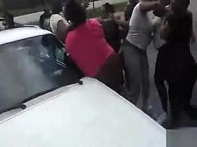 Angry black women fight in a parking lot