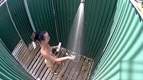 Skinny brunette filly takes a quick shower in the beach cabin