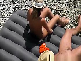 Nudist woman relaxing in beach