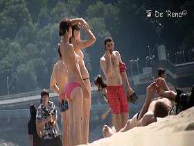Nudist couple by the water