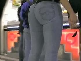 Big booty in blue jeans in a shopping mall candid video