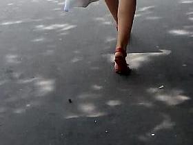Blond walking in the street, white dress, red heels