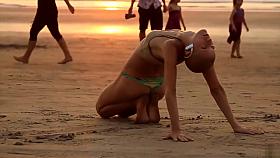 Bald beauty doing yoga by the sea