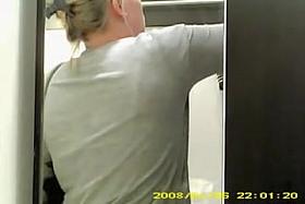 Spy cam woman in change room choosing the brassiere