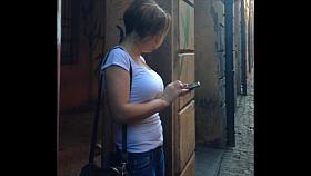 Busty girl playing with her mobile