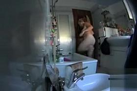 My wife washes her chubby body in the shower cabin
