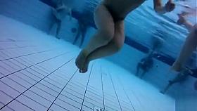 Naked men and women in the pool filmed underwater