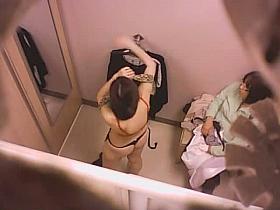 Goog looking girl choosing some underwear in a changing room