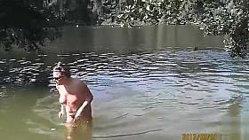 Naked pregnant redhead out on the lake