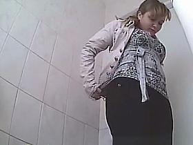 Chubby woman peeing in toilet