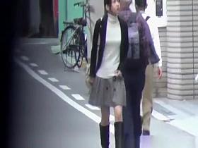 Japanese women pissing beyond a building