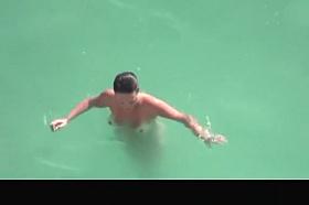 Nudist woman refreshing in the water