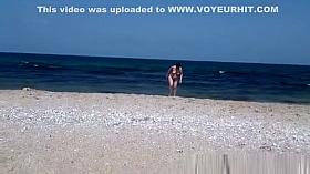 Pregnant nudist woman at beach
