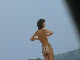 Topless sleek hotties on the nude beach getting filmed by a voyeur