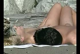 This teenage blonde is so sweet and sexy liyng on the beach