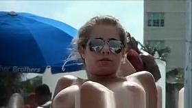 Topless beach girl with massive tits