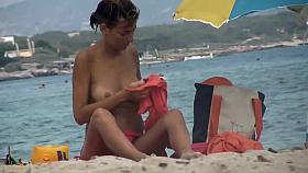 Hot nudist yawns at beach