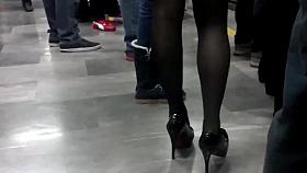 Black stilettos waiting for the train