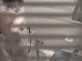 Naked blonde girl soaps up in a shower spy cam video