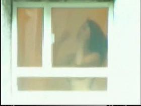 A horny voyeur loves filming hot girls thru the window.
